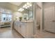 Elegant bathroom with double vanity, large mirror, and separate toilet area at 2705 Serenity Meadow Dr, Kissimmee, FL 34744
