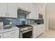Modern kitchen with white cabinets, granite countertops, and stainless steel appliances at 2705 Serenity Meadow Dr, Kissimmee, FL 34744