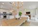 Open concept kitchen and dining area, featuring modern appliances and a large wooden table at 2705 Serenity Meadow Dr, Kissimmee, FL 34744