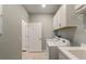 Clean laundry room with washer, dryer, cabinets, and access to other rooms at 2705 Serenity Meadow Dr, Kissimmee, FL 34744