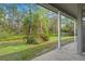 View of the spacious backyard with large trees as seen from the covered lanai at 293 Saxony Ct, Winter Springs, FL 32708