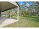 Backyard with a covered lanai, beautiful trees and a large grassy area at 293 Saxony Ct, Winter Springs, FL 32708