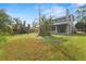 Spacious green backyard featuring large trees and a view of the back of the home at 293 Saxony Ct, Winter Springs, FL 32708