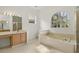 Bright bathroom featuring a separate tub, shower, and window with natural light at 293 Saxony Ct, Winter Springs, FL 32708