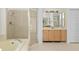 Bathroom with a shower, soaking tub, and wood vanity with lots of natural light at 293 Saxony Ct, Winter Springs, FL 32708