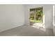 Bright carpeted bedroom with a sliding door access to the outside patio providing serene views at 293 Saxony Ct, Winter Springs, FL 32708