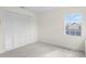 Bedroom featuring neutral carpet, light walls, window and a closet at 293 Saxony Ct, Winter Springs, FL 32708