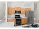 Bright kitchen with stainless steel appliances and light wood cabinetry, offering a modern and functional space at 293 Saxony Ct, Winter Springs, FL 32708