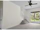 Bright living room with neutral carpet, ceiling fan, stairs, and sliding glass doors leading to the backyard at 293 Saxony Ct, Winter Springs, FL 32708
