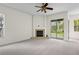 Bright living room with fireplace and sliding glass doors to the patio, merging indoor and outdoor living at 293 Saxony Ct, Winter Springs, FL 32708