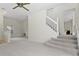 Bright living room with neutral carpet, ceiling fan, and stairs at 293 Saxony Ct, Winter Springs, FL 32708