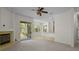 Spacious living area with a fireplace, sliding door access to the patio and adjacent dining area at 293 Saxony Ct, Winter Springs, FL 32708