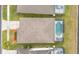 Aerial view featuring a home with a pool and lanai, well-manicured lawns, and mature landscaping at 2983 Sunset Vista Blvd, Kissimmee, FL 34747