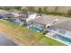 Aerial view of homes each featuring a screened pool in a desirable neighborhood at 2983 Sunset Vista Blvd, Kissimmee, FL 34747