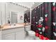 Clean bathroom with shower/tub combo, vanity, and Mickey Mouse accents at 2983 Sunset Vista Blvd, Kissimmee, FL 34747