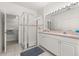 Bathroom features a glass-enclosed shower and double vanity with updated fixtures at 2983 Sunset Vista Blvd, Kissimmee, FL 34747