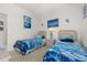 Bedroom featuring two twin beds, artwork, and a side table at 2983 Sunset Vista Blvd, Kissimmee, FL 34747