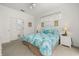Comfortable bedroom with tropical-themed bedding, bright white walls, and lots of natural light at 2983 Sunset Vista Blvd, Kissimmee, FL 34747