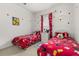 Themed bedroom with two twin beds, cartoon decor, and natural light from a window at 2983 Sunset Vista Blvd, Kissimmee, FL 34747