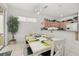 Open floor plan with dining area that has tile flooring and a modern white table at 2983 Sunset Vista Blvd, Kissimmee, FL 34747