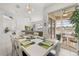 Dining room with white table, six chairs, and access to patio at 2983 Sunset Vista Blvd, Kissimmee, FL 34747
