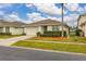 Charming one-story home featuring a manicured front yard and attached garage at 2983 Sunset Vista Blvd, Kissimmee, FL 34747