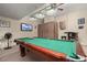 Fun game room complete with a pool table, tv and bar setup, perfect for entertaining at 2983 Sunset Vista Blvd, Kissimmee, FL 34747