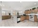 Open kitchen layout featuring light wood cabinets and a view into the living area at 2983 Sunset Vista Blvd, Kissimmee, FL 34747