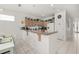 Bright kitchen with tiled floors, light wood cabinetry, and a breakfast bar at 2983 Sunset Vista Blvd, Kissimmee, FL 34747