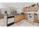 Open kitchen with island, white appliances, and tile floor at 2983 Sunset Vista Blvd, Kissimmee, FL 34747