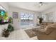 Spacious living room with pool and lake view from sliding doors at 2983 Sunset Vista Blvd, Kissimmee, FL 34747