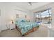 Serene main bedroom with a view of the screened pool area and lake at 2983 Sunset Vista Blvd, Kissimmee, FL 34747