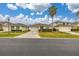 Houses with garages and landscaping on a quiet street at 2983 Sunset Vista Blvd, Kissimmee, FL 34747