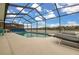 Enclosed pool area with lake view, lounge chairs, and patio furniture at 2983 Sunset Vista Blvd, Kissimmee, FL 34747