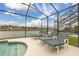Screened pool deck with waterfront views and lounge chairs. Perfect for relaxing by the pool at 2983 Sunset Vista Blvd, Kissimmee, FL 34747