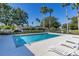 Community pool with lounge chairs and fenced area at 2983 Sunset Vista Blvd, Kissimmee, FL 34747