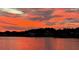 Beautiful water view with a colorful sunset reflecting on the calm water at 2983 Sunset Vista Blvd, Kissimmee, FL 34747