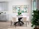 Bright dining area with round table, four chairs, and modern art pieces at 321 Castle Dr, Lake Alfred, FL 33850