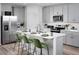 Modern kitchen with gray cabinets, stainless steel appliances, and an island with seating at 321 Castle Dr, Lake Alfred, FL 33850