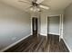 Cozy bedroom with wood floors, a ceiling fan, and a closet at 3213 Holderness Dr, Kissimmee, FL 34741