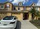 Charming townhome exterior with bright red shutters, balcony, and well-maintained landscaping at 3213 Holderness Dr, Kissimmee, FL 34741