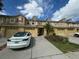 Charming townhome exterior with bright red shutters, balcony, and well-maintained landscaping at 3213 Holderness Dr, Kissimmee, FL 34741