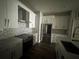Modern kitchen with stainless steel appliances, white cabinets, and backsplash at 3213 Holderness Dr, Kissimmee, FL 34741