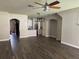 Spacious open-concept living room with wood flooring and modern ceiling fan at 3213 Holderness Dr, Kissimmee, FL 34741