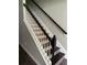 Close up view of a staircase with dark wood treads and white risers, complemented by a dark wood banister at 3213 Holderness Dr, Kissimmee, FL 34741