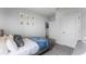 Cozy bedroom with a gray bed frame, blue bedding, and marine-themed wall art at 3431 Fort Mellon Ln, Sanford, FL 32773