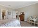 Bedroom with desk and dresser in neutral paint with views into another room and the bathroom at 3525 Belland Cir # A, Clermont, FL 34711