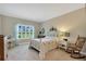 Inviting bedroom with soft natural light, neutral paint, a white bed frame, and a rocking chair at 3525 Belland Cir # A, Clermont, FL 34711