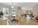 Open concept dining area featuring tile floors, backyard views, and easy access to both the kitchen and living spaces at 3525 Belland Cir # A, Clermont, FL 34711