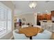 Open-concept dining area with views of the kitchen, living room, and lots of natural light at 3525 Belland Cir # A, Clermont, FL 34711